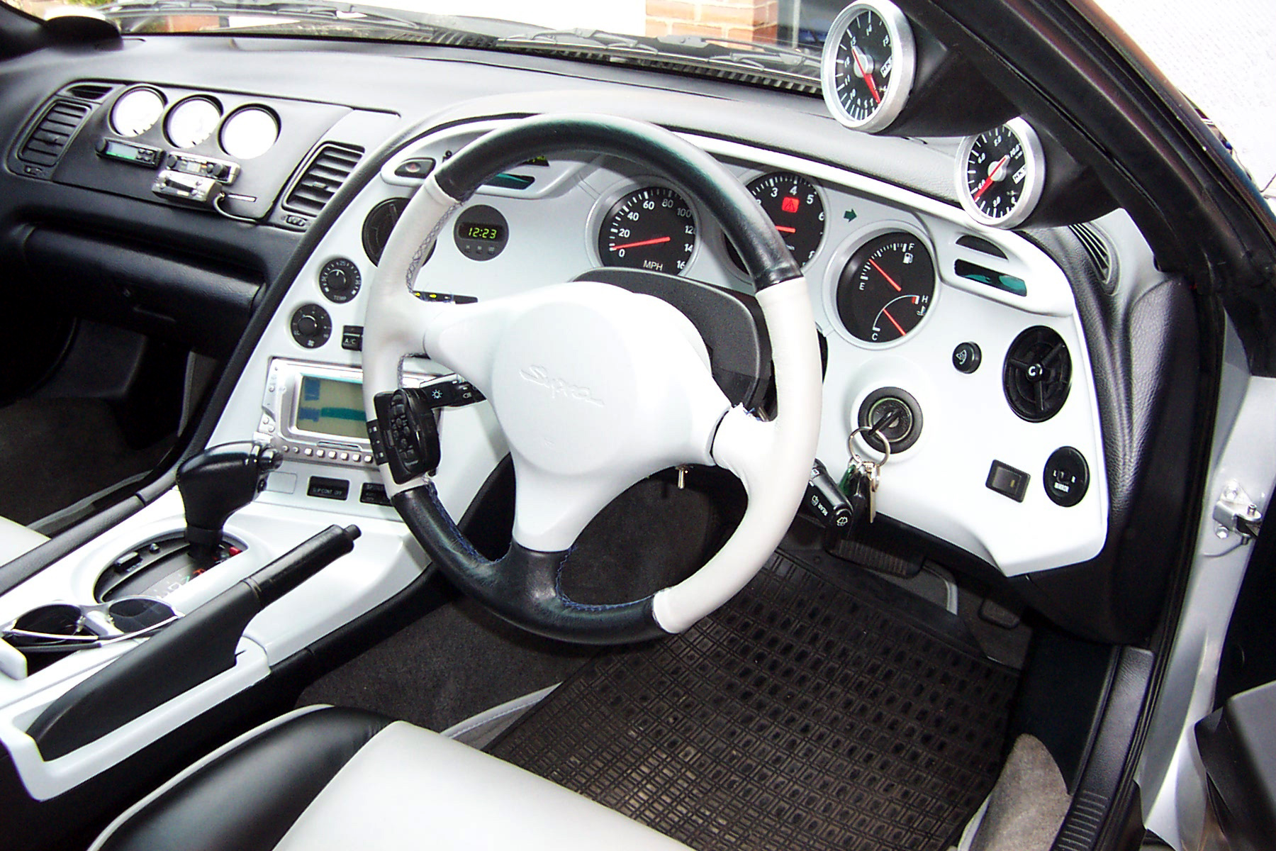 White+and+black+dashboard%2C+seats+and+steering+wheel
